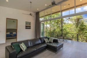 Spacious living room with large windows and mountain views in Costa Rica.