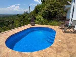 Swimming pool overlooking lush jungle and distant mountains in Dominical.