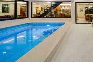 Indoor swimming pool with glass walls and modern design in Costa Rica estate.