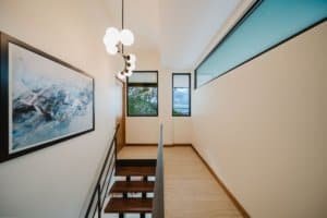 Bright hallway with large windows and contemporary lighting fixtures.