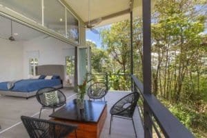 Balcony with seating overlooking lush forest in Dominical, Costa Rica.