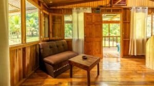 Interior of a rustic mountain home in Costa Rica with wooden walls and furniture.