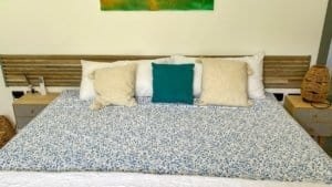 Comfortable bedroom with a large bed, decorative pillows, and modern decor.