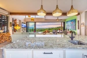 Open-concept living area with mountain views, modern decor, and large windows.
