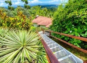 Scenic view of lush tropical landscape and ocean from hillside property.