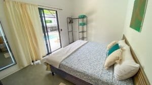 Comfortable bedroom with balcony access near Marino Ballena National Park.