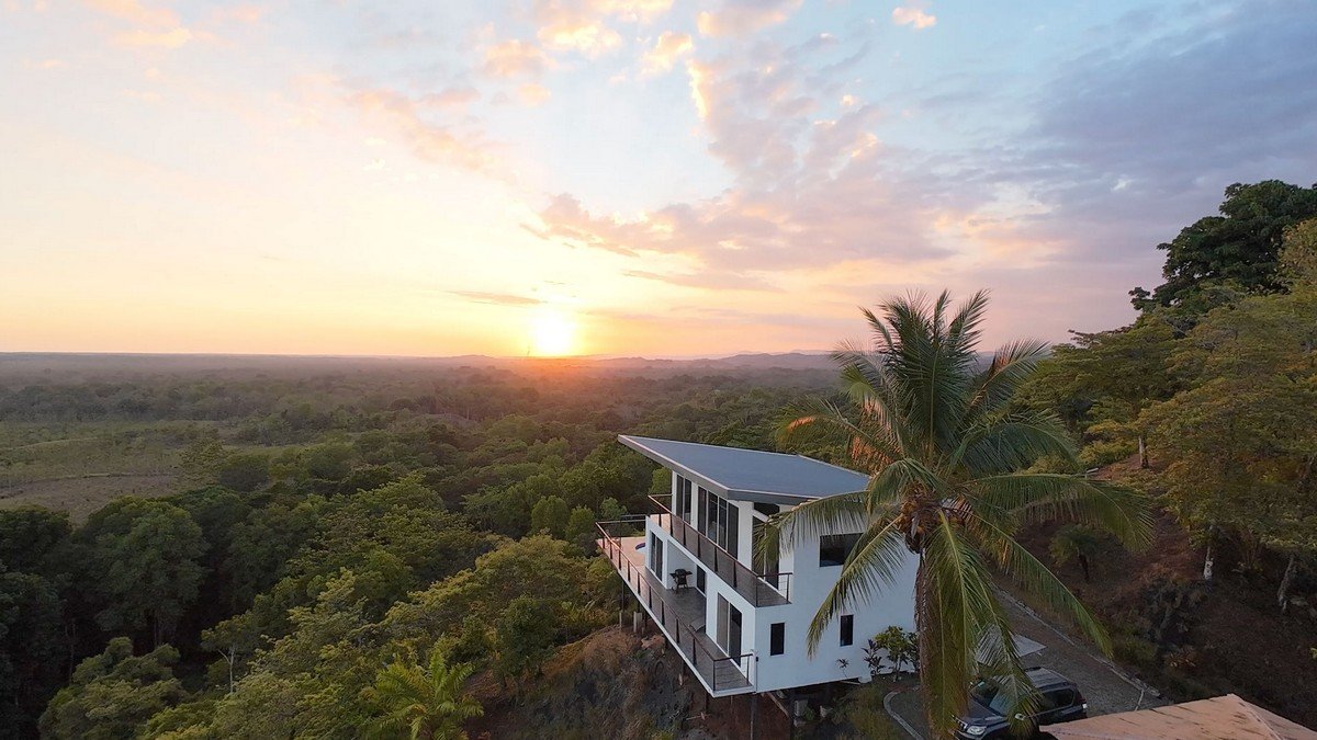 Contemporary home overlooking lush forest and sunset in Dominical, Costa Rica.