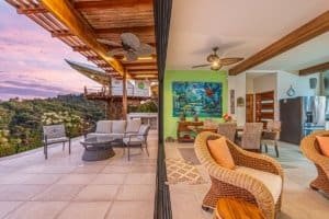 Modern living room with mountain views, outdoor terrace, and stylish decor.