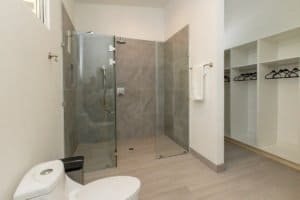 Contemporary bathroom with glass shower and walk-in closet in Costa Rica.