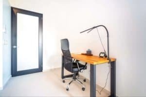 Minimalist home office with desk, chair, and reading lamp in Dominical.