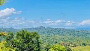 Scenic view of lush green hills and ocean in Dominical, Costa Rica.