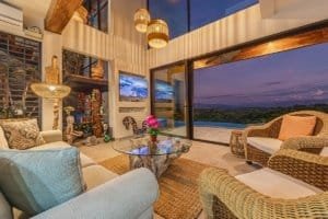 Elegant living room with mountain views, infinity pool, and hot tub in Costa Rica.