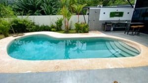 Private backyard pool with lush tropical plants in Dominical, Costa Rica.