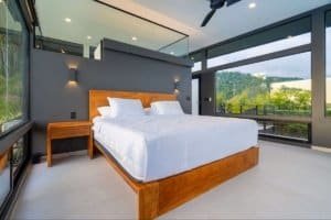 Modern bedroom with large windows and mountain views in Dominical.