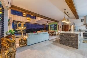 Interior of a modern Costa Rican home with mountain views, open kitchen, and stylish decor.