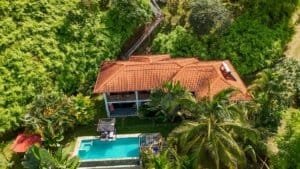 Aerial view of a home and boutique lodge with ocean view in Dominical, Costa Rica.