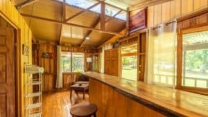Interior of a wooden mountain home with large windows and natural light.