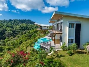 Modern Costa Rica estate with infinity pool and mountain backdrop.