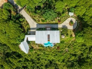Aerial view of a luxury estate with infinity pool and mountain views in Costa Rica.