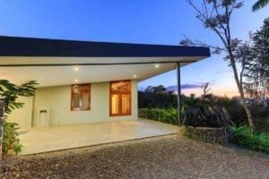 Modern mountain retreat home with panoramic views and spacious patio.