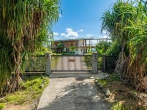 Modern luxury estate with mountain views, infinity pool, and lush tropical landscaping.