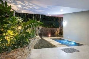 Modern pool with lush tropical garden and mountain view in Dominical.