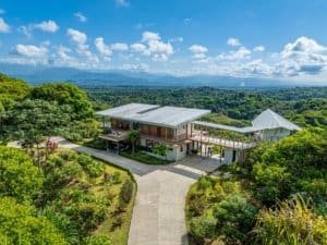 Modern estate with infinity pool, hot tub, and mountain backdrop in Dominical.