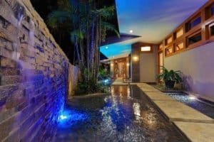 Elegant pool area with waterfall and mountain view in Dominical.