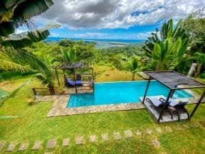 Scenic view of pool with ocean and lush greenery in Dominical, Costa Rica.
