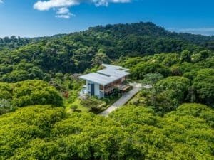 Modern estate surrounded by lush rainforest with mountain views in Dominical.