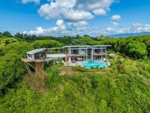 Modern Costa Rica estate with infinity pool and mountain backdrop.