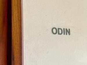 Room sign with the name Odin on a white wall in Dominical.