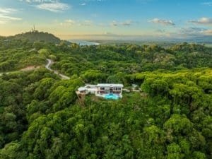 Modern estate with infinity pool and hot tub surrounded by lush greenery in Dominical.