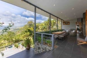Spacious balcony with mountain view and lush greenery in Dominical.