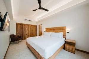 Modern bedroom with wooden accents and ocean view in Costa Rica.