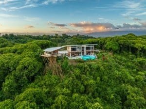 Modern luxury estate with infinity pool and hot tub in lush Costa Rican forest.