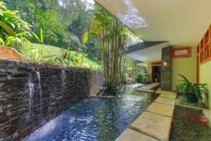 Indoor pool with waterfall and lush greenery in Dominical.