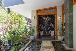 Elegant entrance with tropical plants and mountain view in Dominical.