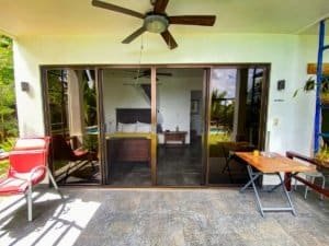 Costa Rican home with ocean view, outdoor patio, and lush greenery.