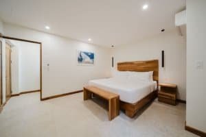 Modern bedroom with wooden furniture and ocean view in Costa Rica.
