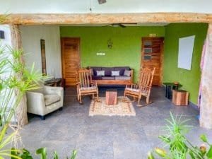 Interior of a Costa Rican home with green walls, wooden furniture, and natural decor.
