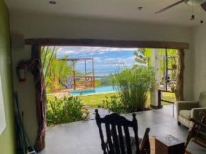 Beautiful ocean view from a Costa Rican home with pool and lush greenery.