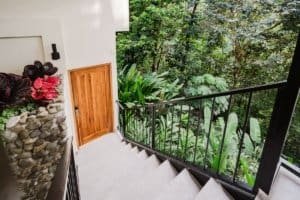 Balcony with black railing overlooking lush jungle in Dominical, Costa Rica.