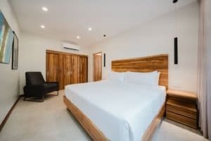 Modern bedroom with wooden accents and jungle view in Costa Rica.