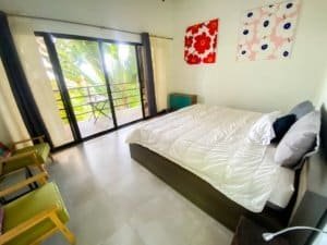 Bedroom with balcony and tropical greenery in Dominical Costa Rica.