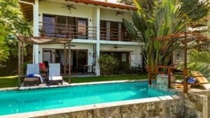 Beautiful Costa Rican home with pool, lush garden, and ocean view.