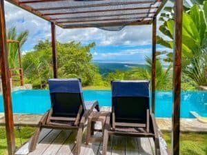 Relaxing pool with ocean view and lush greenery in Dominical, Costa Rica.