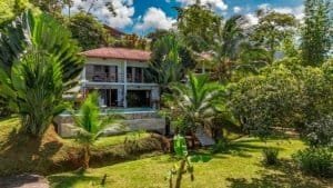 Luxury boutique lodge with ocean view and lush tropical garden.