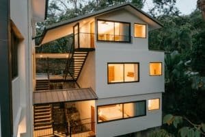 Contemporary house with large windows in lush rainforest setting near Dominical.
