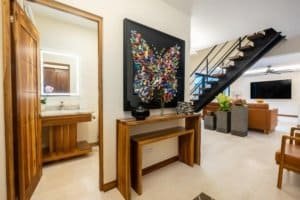 Modern interior with staircase, art piece, and living area in Dominical estate.